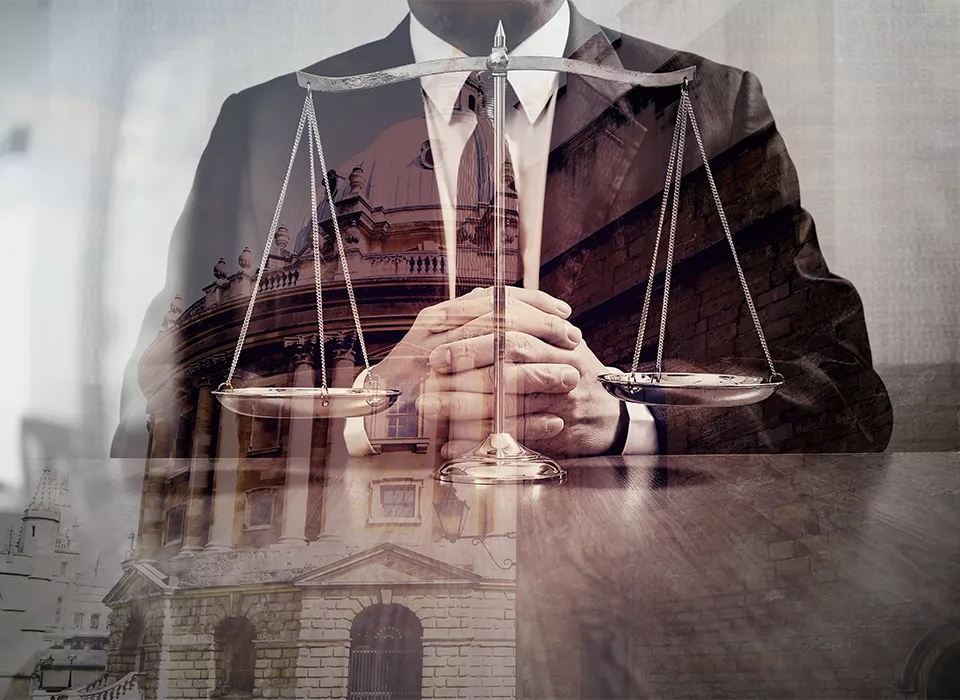 justice and law concept. Male lawyer in the office with brass scale on wooden table with London city background, double exposure